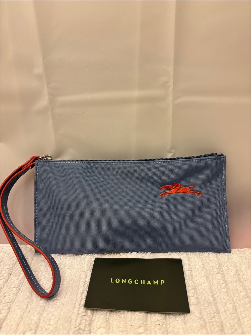Longchamp Slate Blue Wristlet Pouch with Orange Horse Emblem